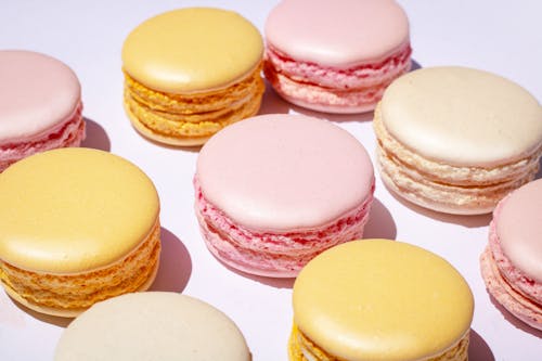 Pink and Yellow Macarons on Pink Surface