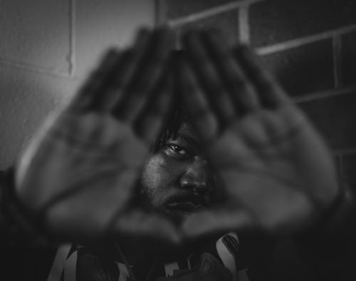 Black and White of  Man Doing Triangle Sign with his Hands