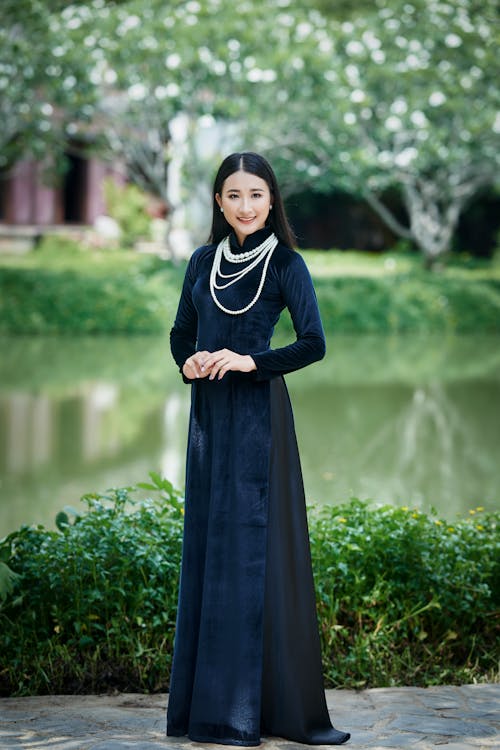 An Elegant Woman in Black Gown Standing