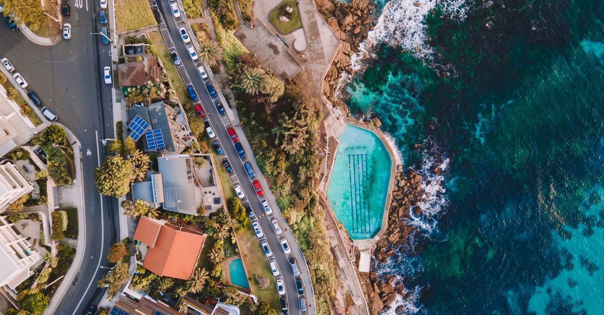 A stunning aerial photograph of Bronte Beach rock pool and coastal road in NSW, Australia.