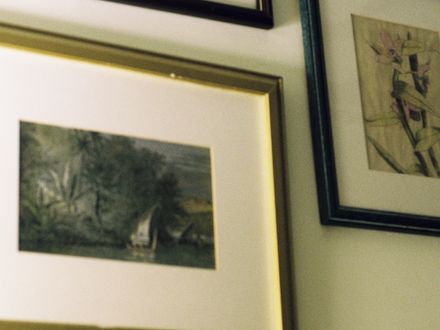 Gallery wall of framed pictures hung evenly on a wall