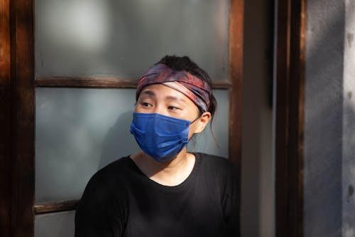 Free Close-Up Shot of a Woman in Black Top Wearing a Face Mask Stock Photo