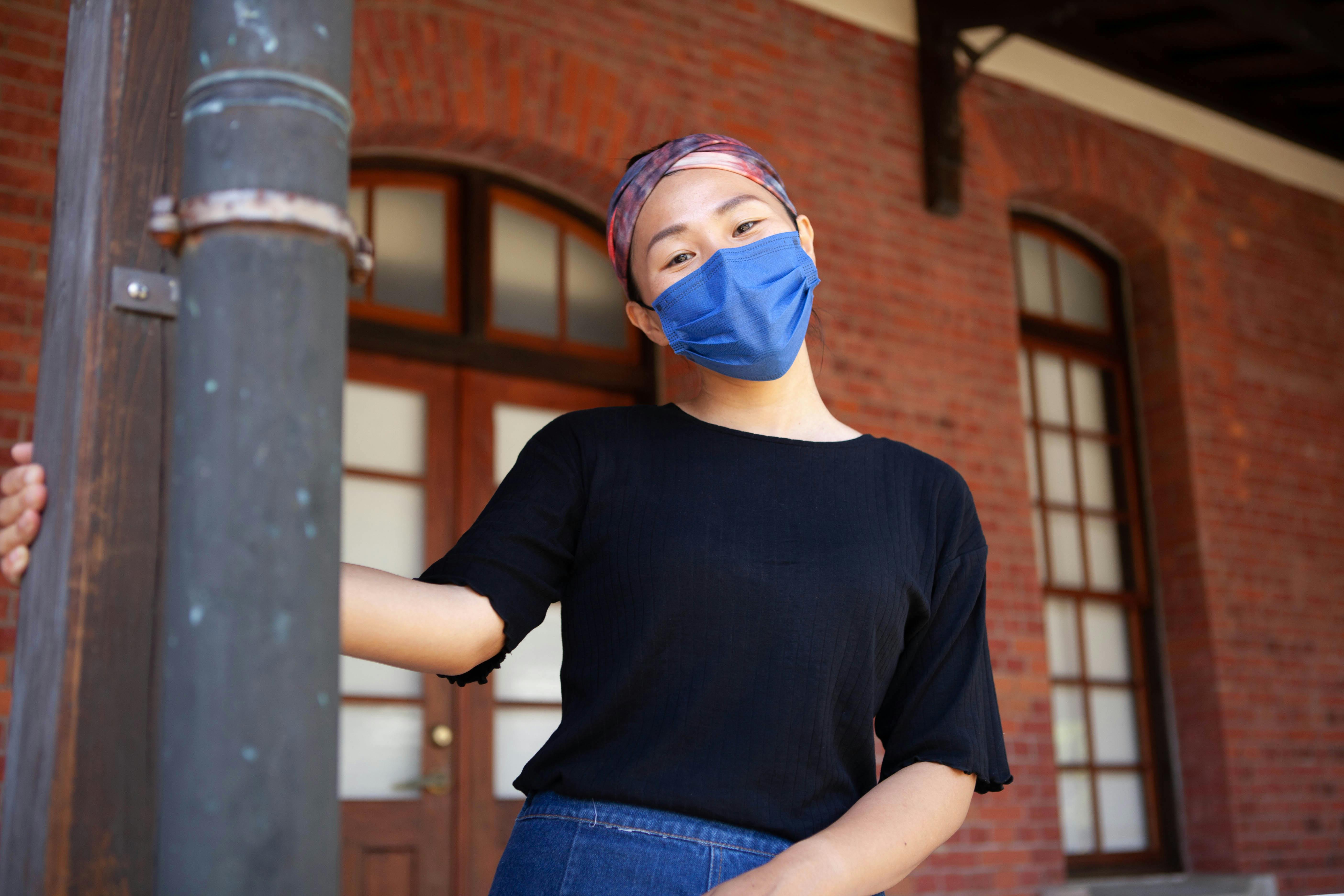 a woman in black top wearing a face mask