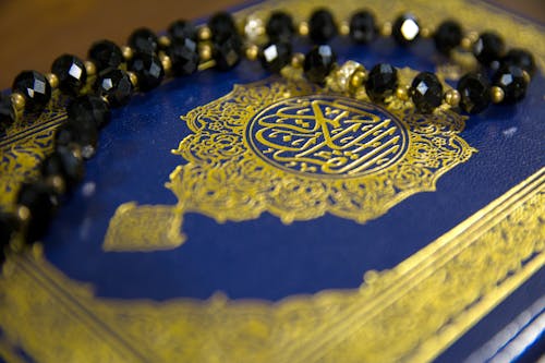 Free Close-Up Shot of Prayer Beads on a Book Stock Photo