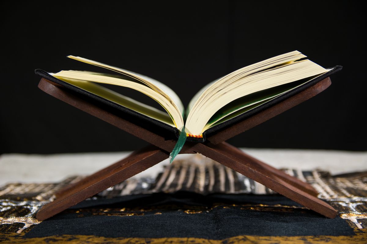Open Qur'an on a wooden stand
