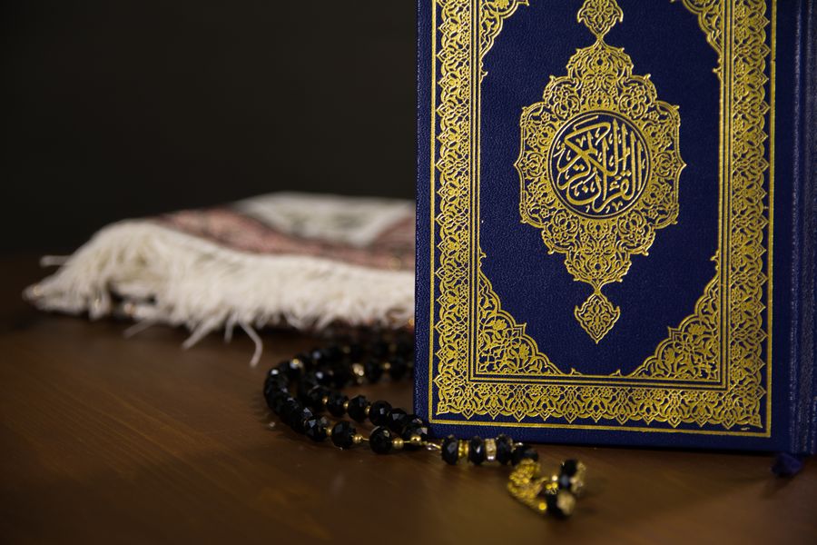 Blue and gold Quran with prayer beads for Islamic studies