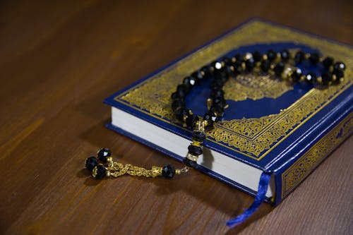 Free Close-Up Shot of Prayer Beads on a Book Stock Photo