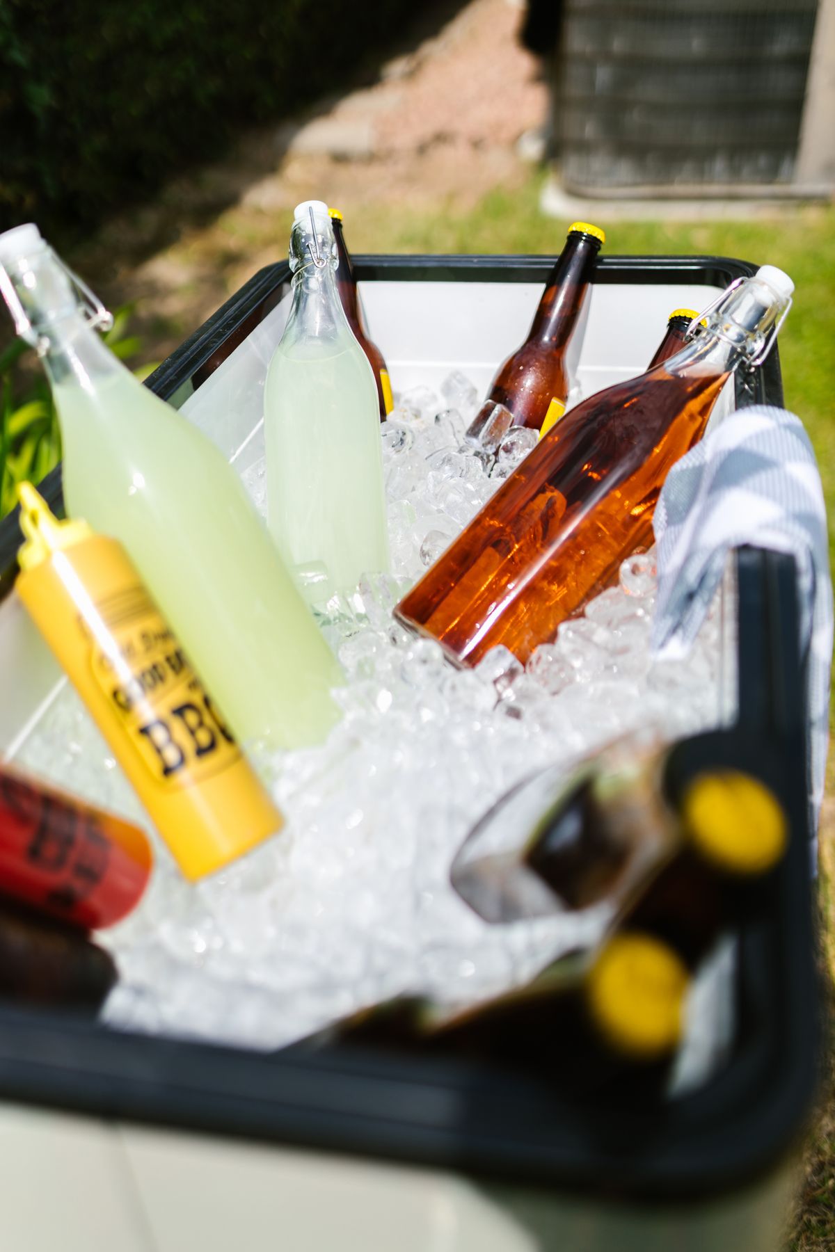 Bottled beverages chilling on ice in a cooler box