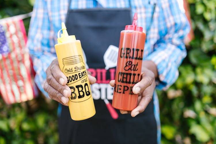 Close-Up Shot Of A Person Holding Condiments