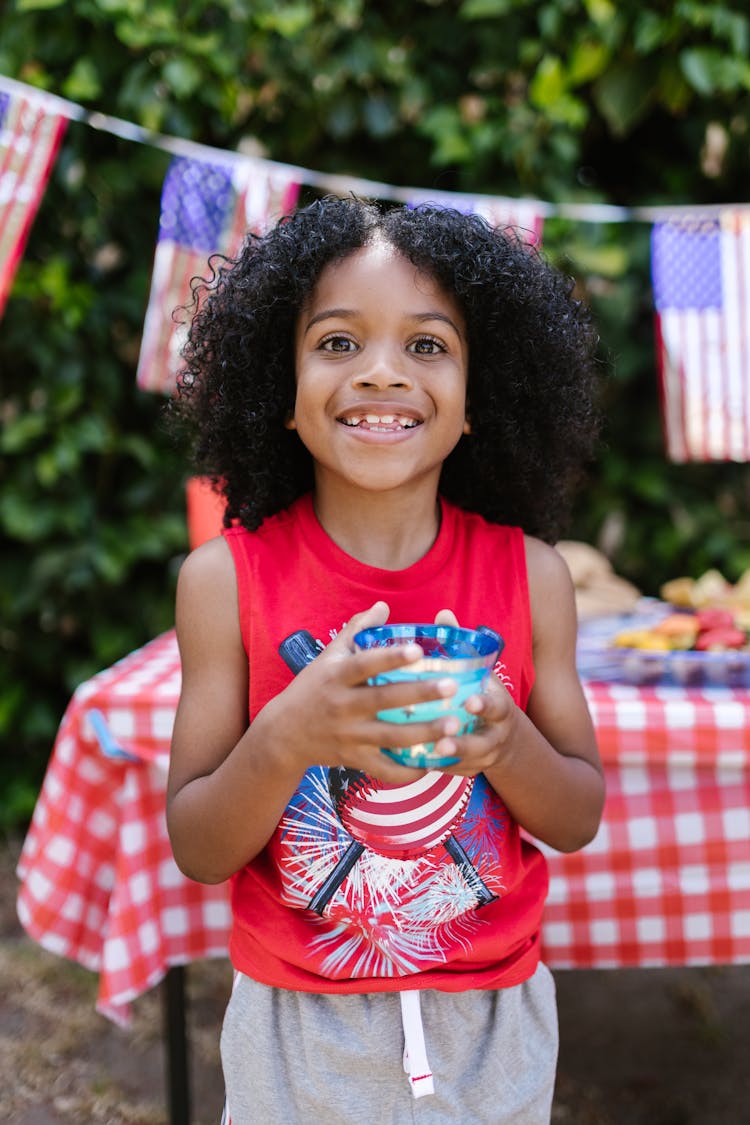 Cute Child Holding A Drink