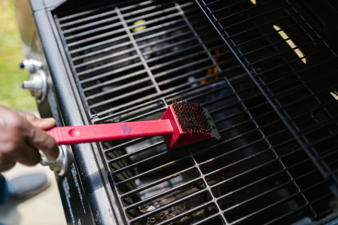 Free Person Brushing the Griller Stock Photo
