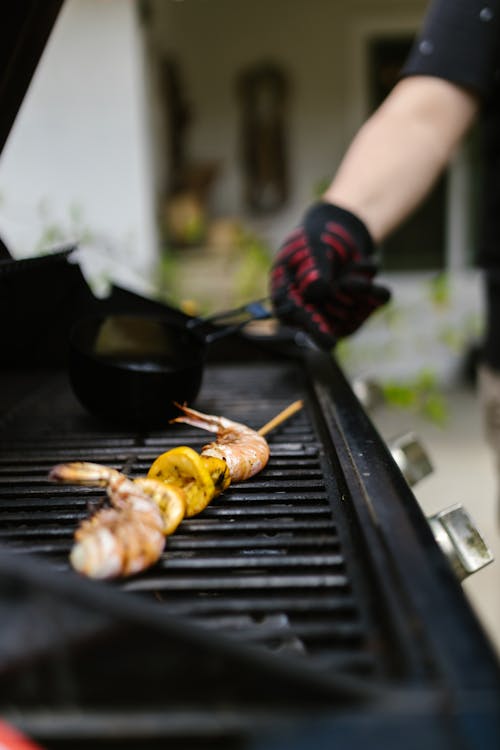 Person Grilling Shrimps