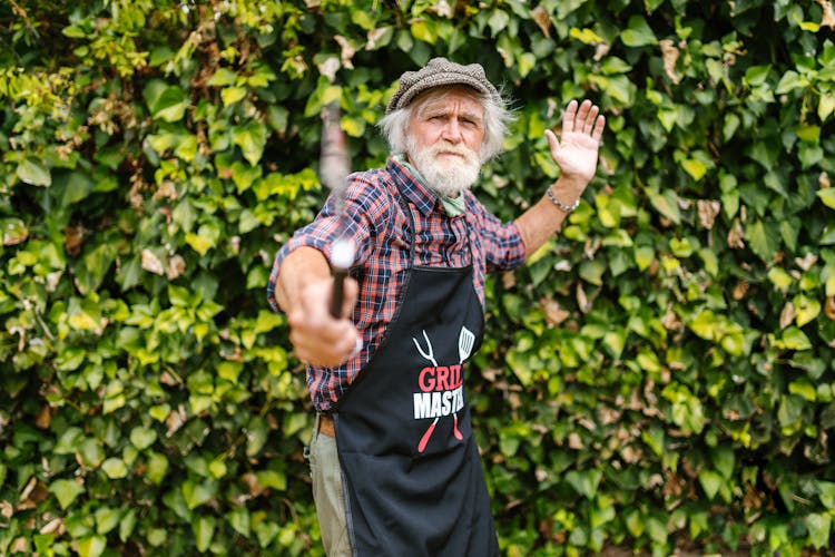 Elderly Man Holding A Spatula