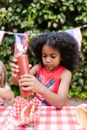 Girl in Pink Tank Top Holding Red Plastic Bottle