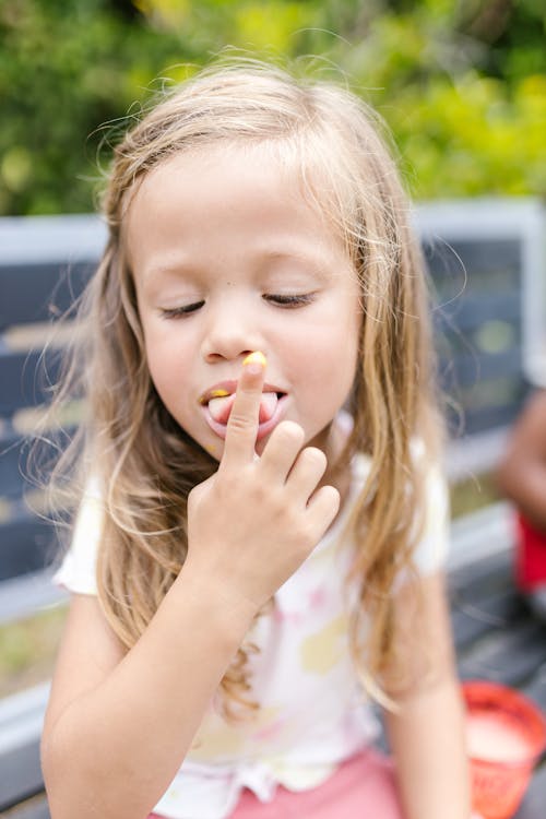 Girl Licking the Sauce on her Finger