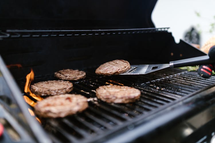 Close-up Shot Of A Grilling Burgers