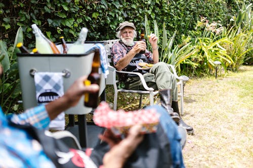 Elderly Man Sitting while Holding Beer