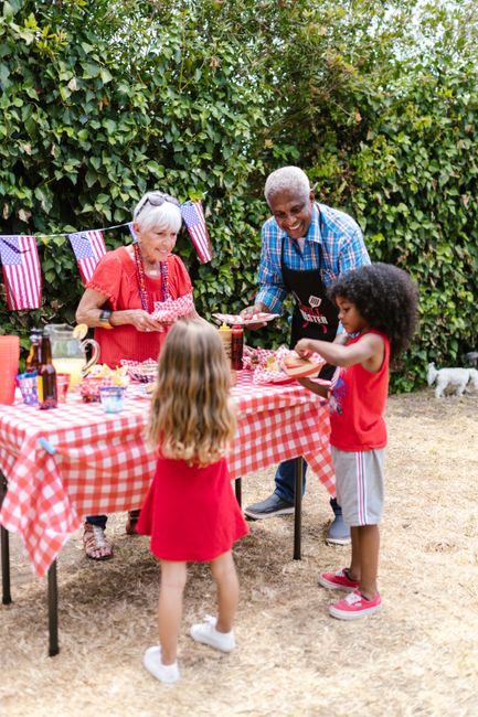 Photo by RDNE Stock project on Pexels Grandparents and kids enjoying a 4th of July picnic with hamburgers.