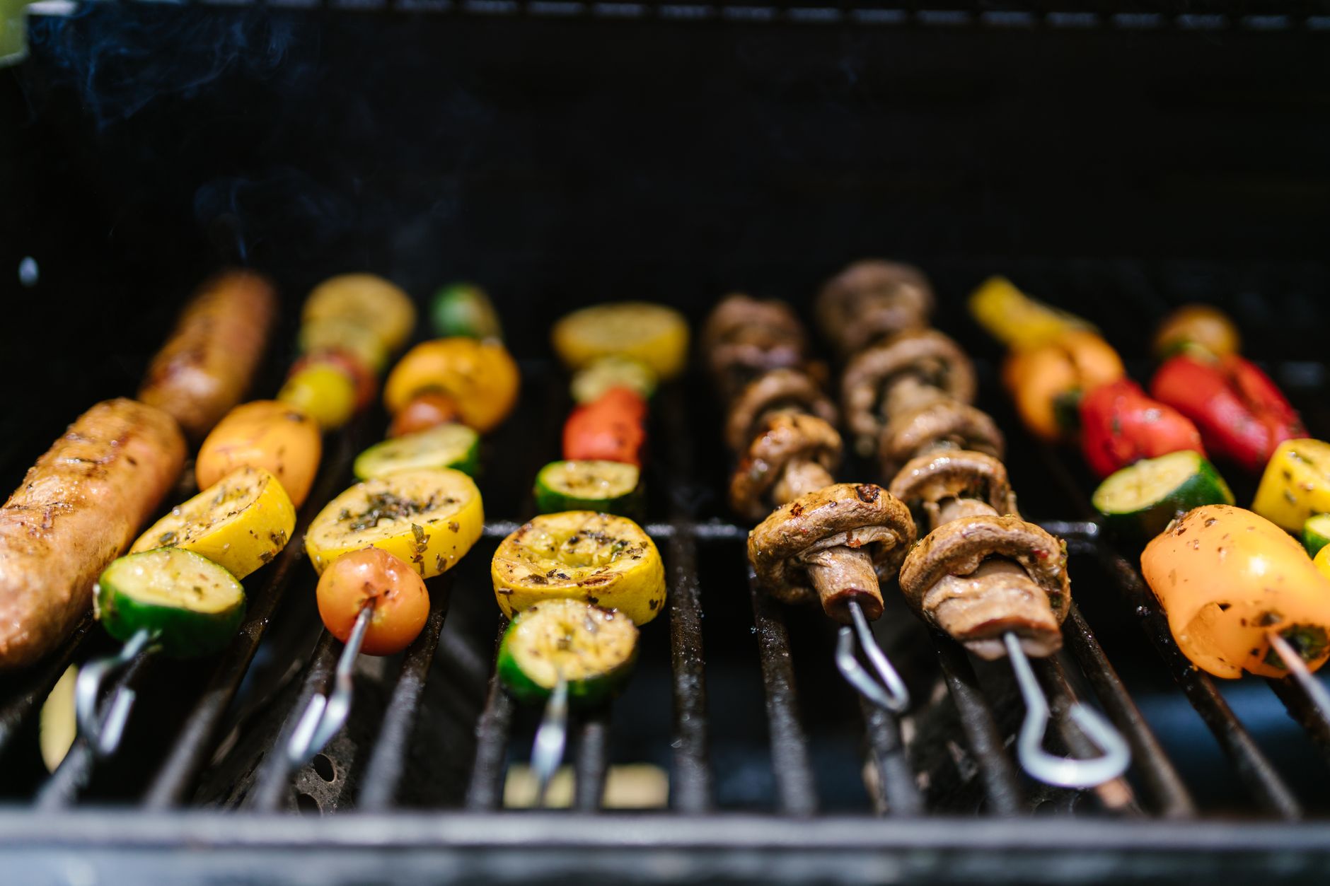 Colorful grilled vegetable skewers with herbs on a plate
