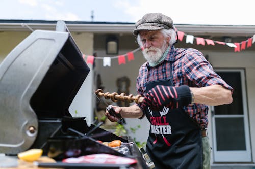 Free Elderly Man Doing Barbecue Stock Photo