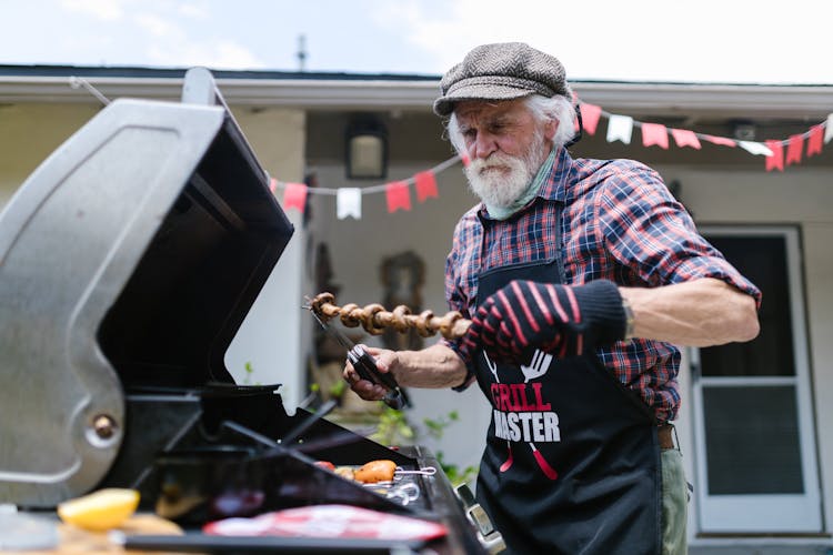 Elderly Man Doing Barbecue