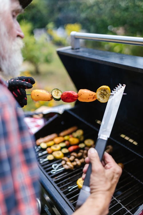 Elderly Man Cooking Barbecue