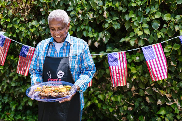 Man Holding A Plate With Food