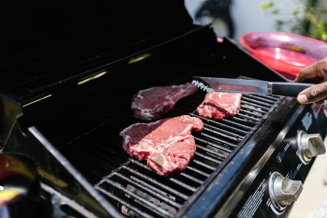 Free Raw Meat on Black Grill Stock Photo
