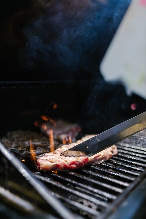 Free Grilled Meat on Black Grill Stock Photo