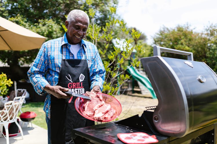 A Man Grilling Meat