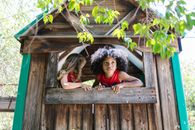 2 Girls Lying on Brown Wooden Stairs