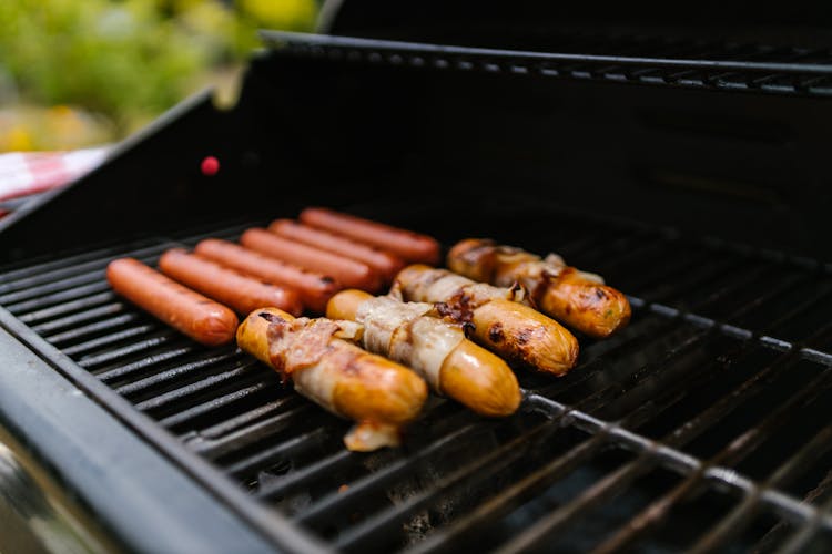 Close-up Grilling Hotdogs In A Griller