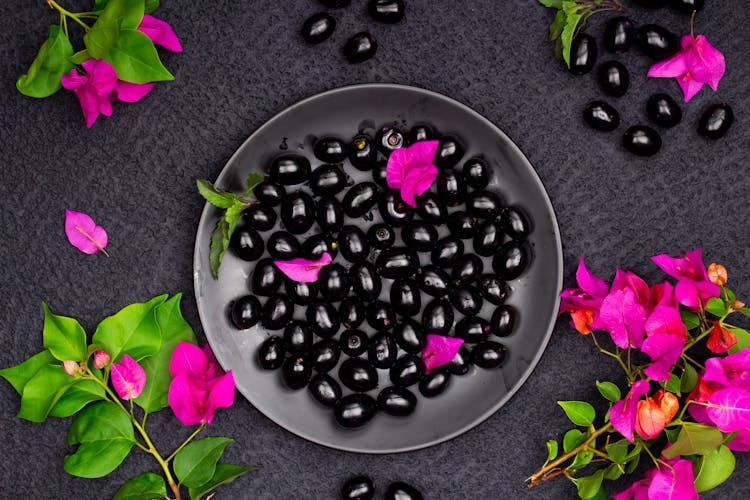 Bowl Of Black Olives And Purple Flowers 