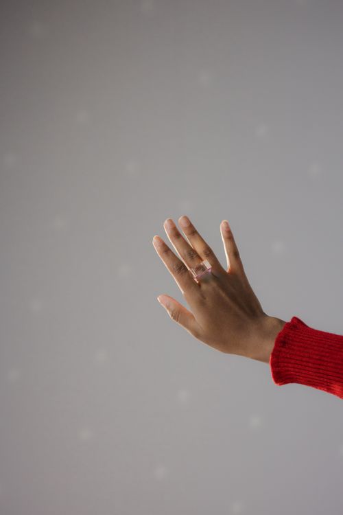 Free Minimalist close-up of a hand wearing a ring, set against a soft background. Stock Photo