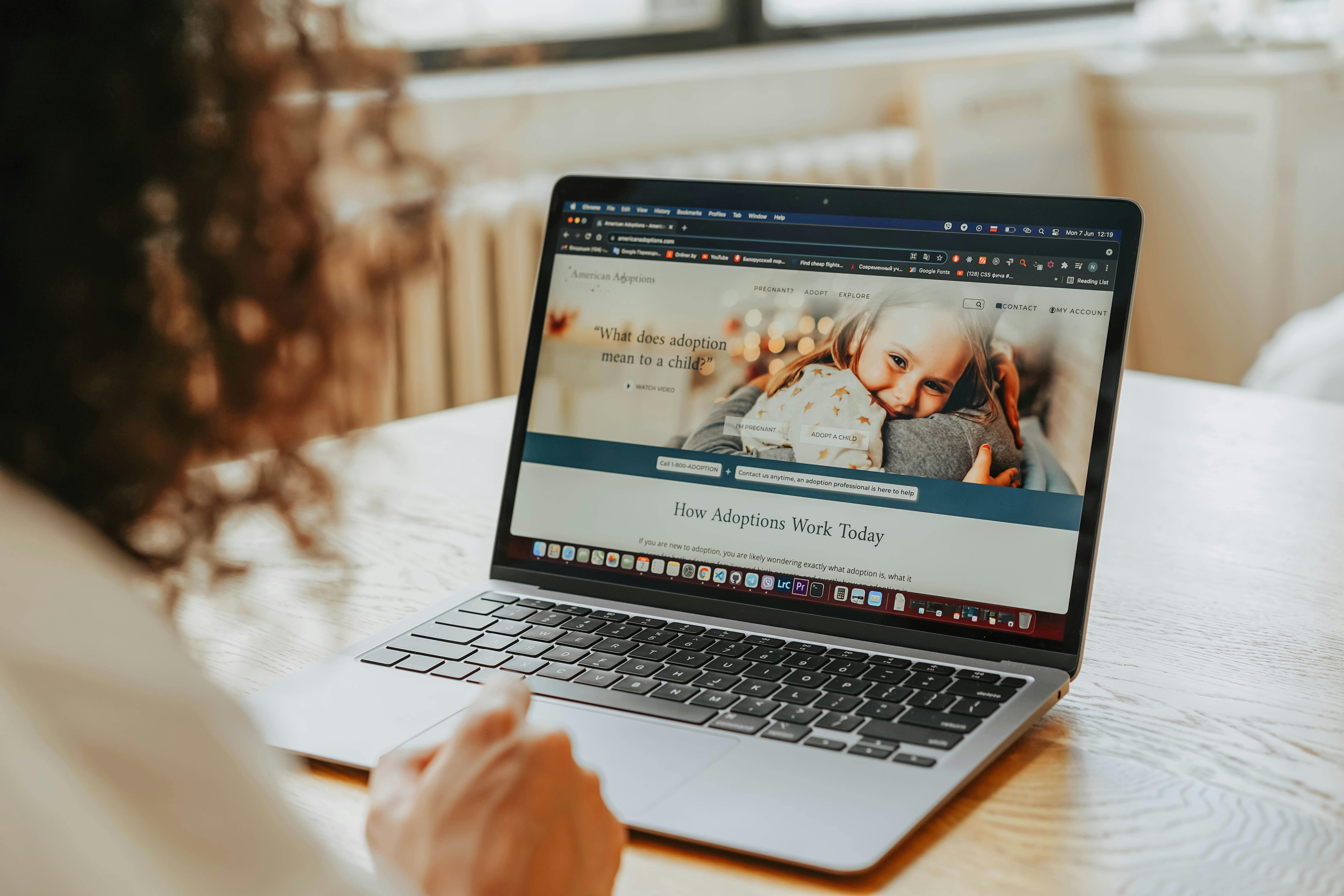 woman looking at the laptop with adoption website