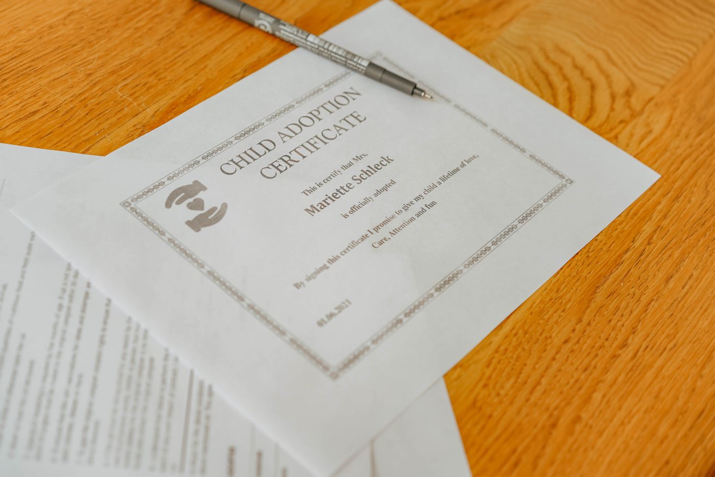 A formal certificate and pen on a desk