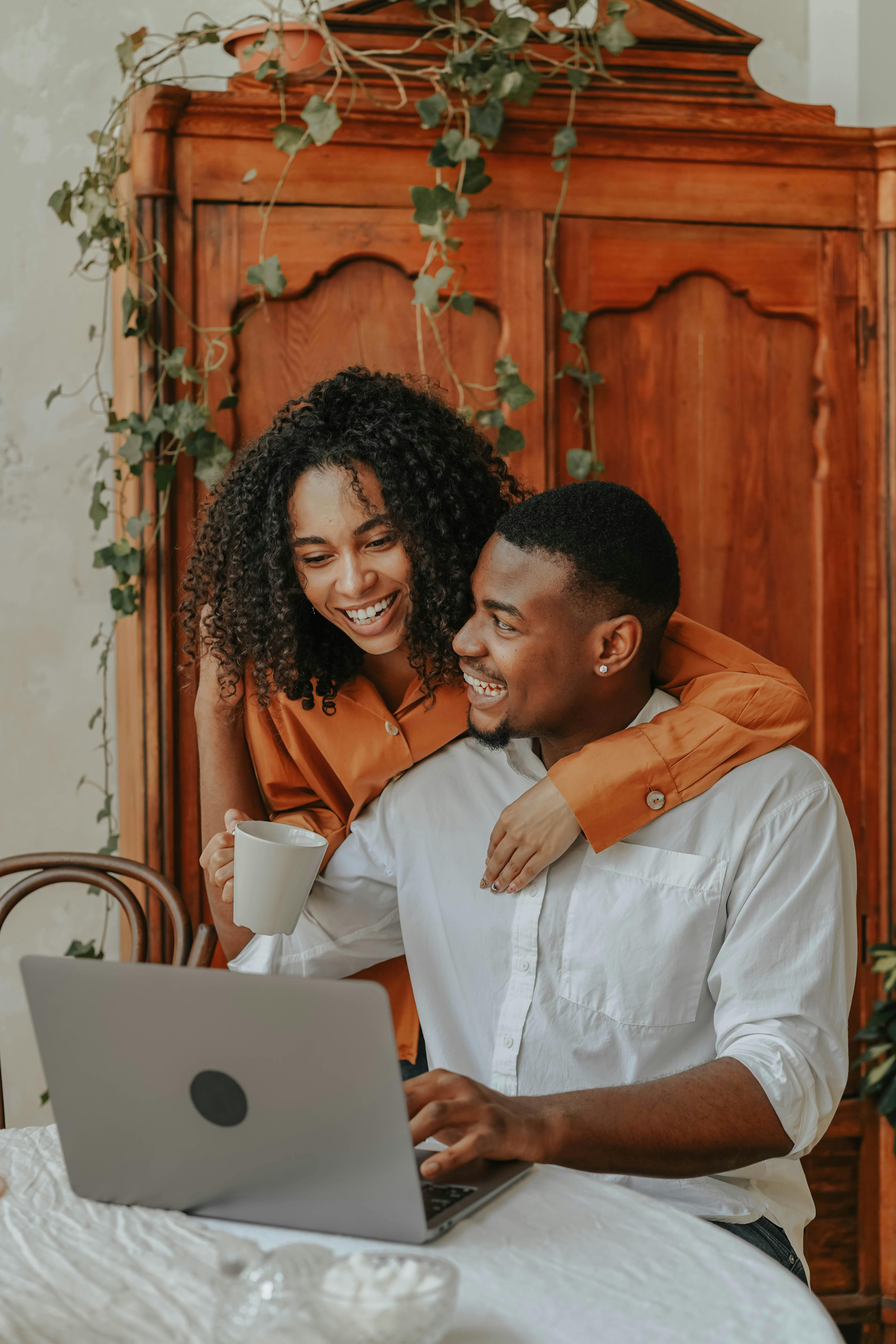 A Happy Couple Using a Laptop Together