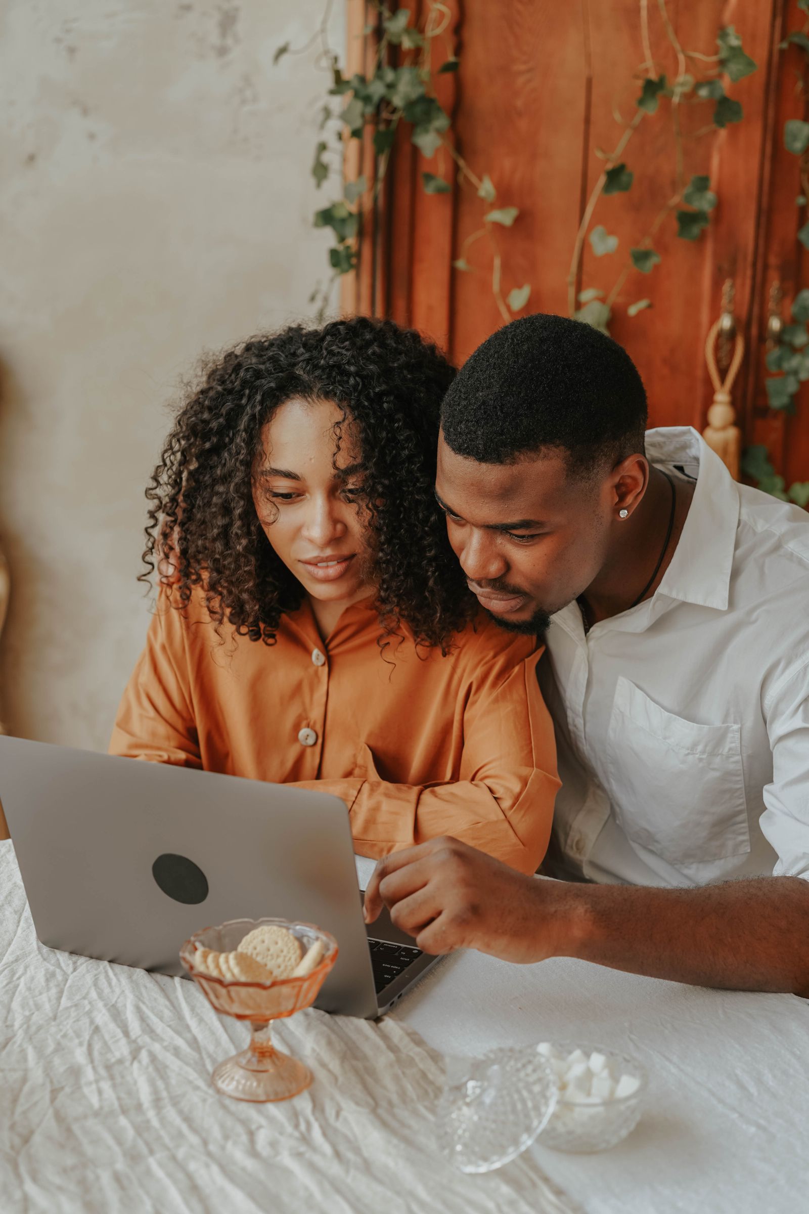 Black couple reviewing financial options together on a laptop