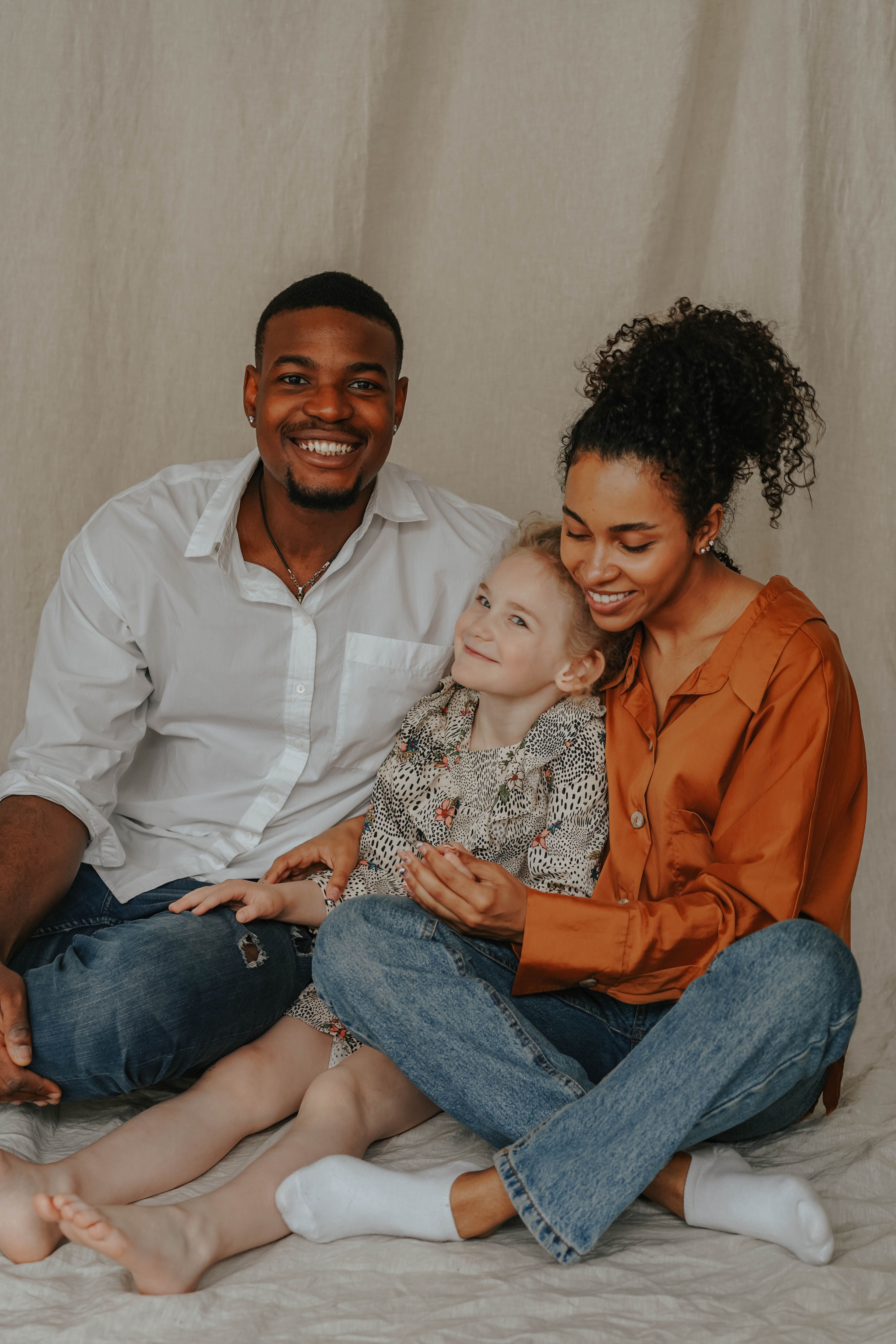Warm family portrait of a happy interracial couple with their child, showcasing love and togetherness.