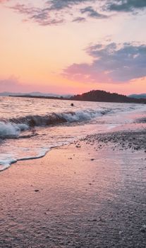 A breathtaking sunset on a quiet beach, highlighting waves and colorful sky.
