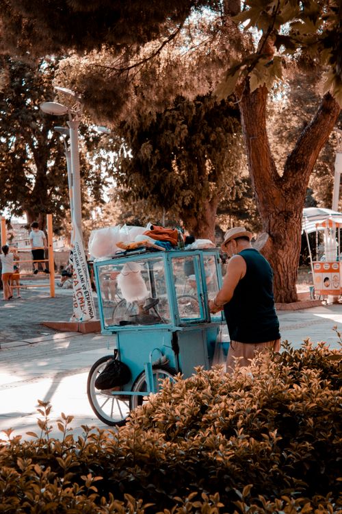 Free A street vendor sells cotton candy in a vibrant Erdek park setting, capturing local culture. Stock Photo