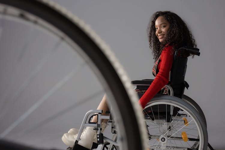 A Cheerful Girl On A Wheelchair