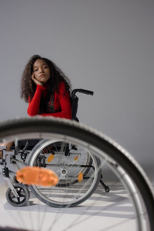 Free A thoughtful woman in a wheelchair indoors, highlighting strength and resilience. Stock Photo