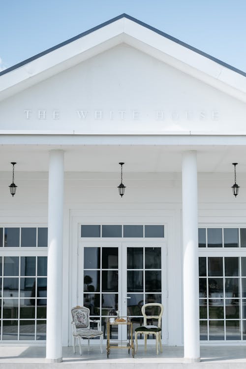 Free A White House with Glass Panels Under the Blue Sky Stock Photo