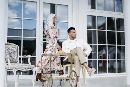 Man and Woman in Headscarf on Patio