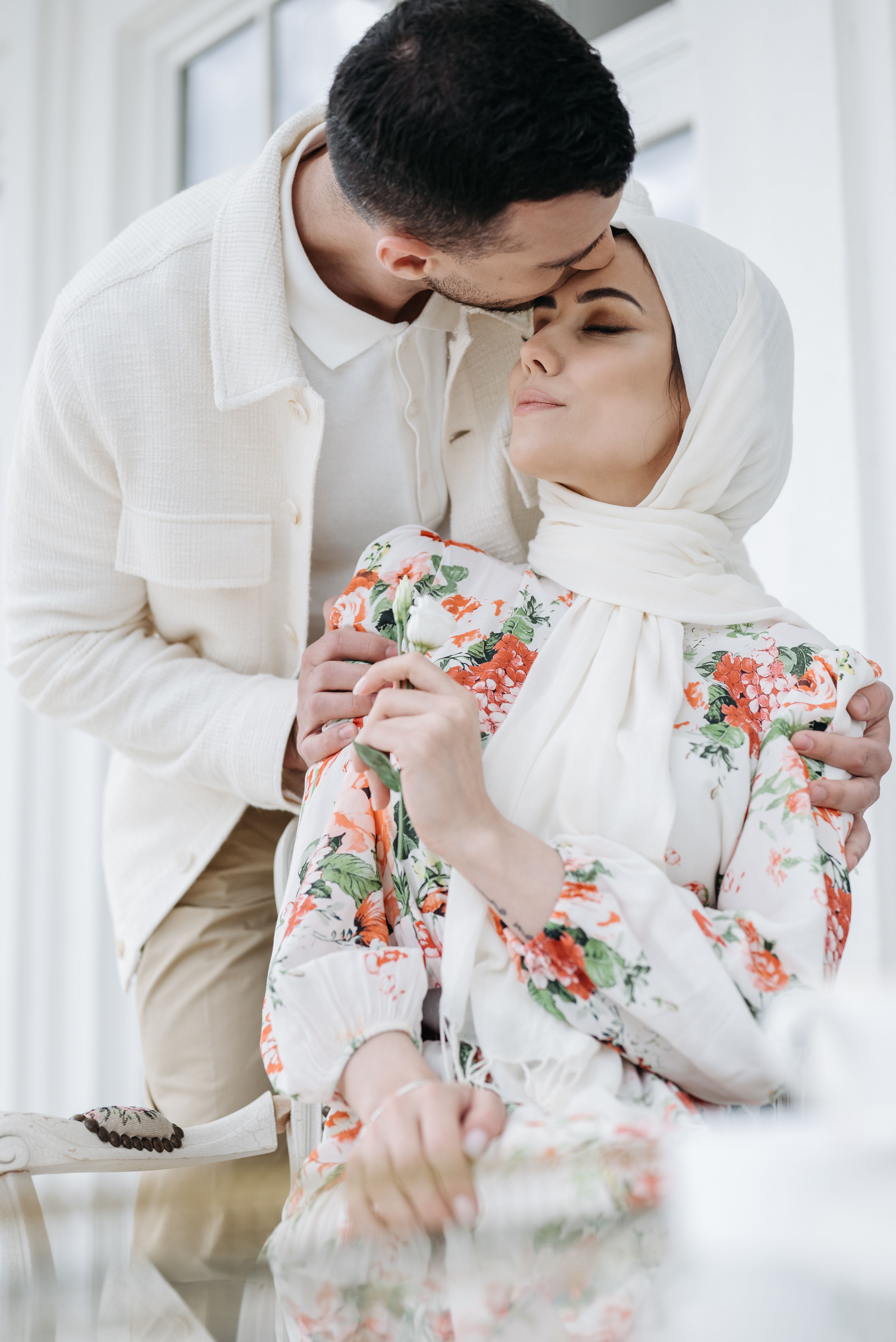 Woman Wearing Black Hijab Holding Man in Black Suit · Free Stock Photo