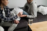 Man in Gray Hoodie Sitting on Couch