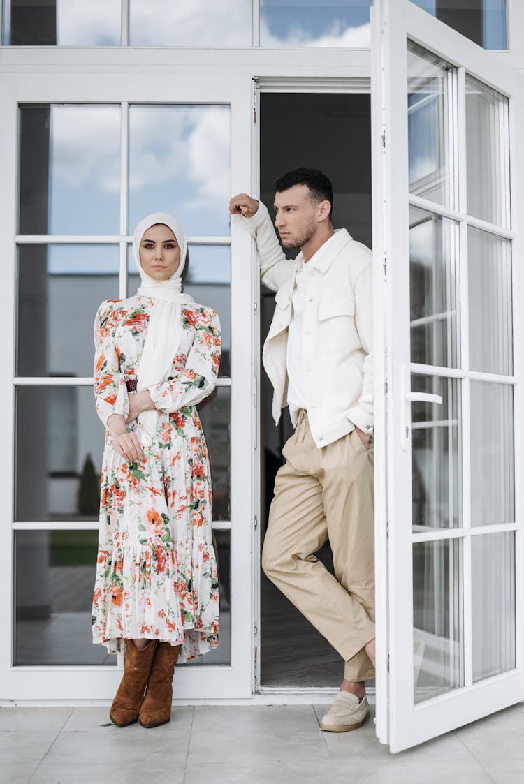 Man And Woman Standing By The French Doors