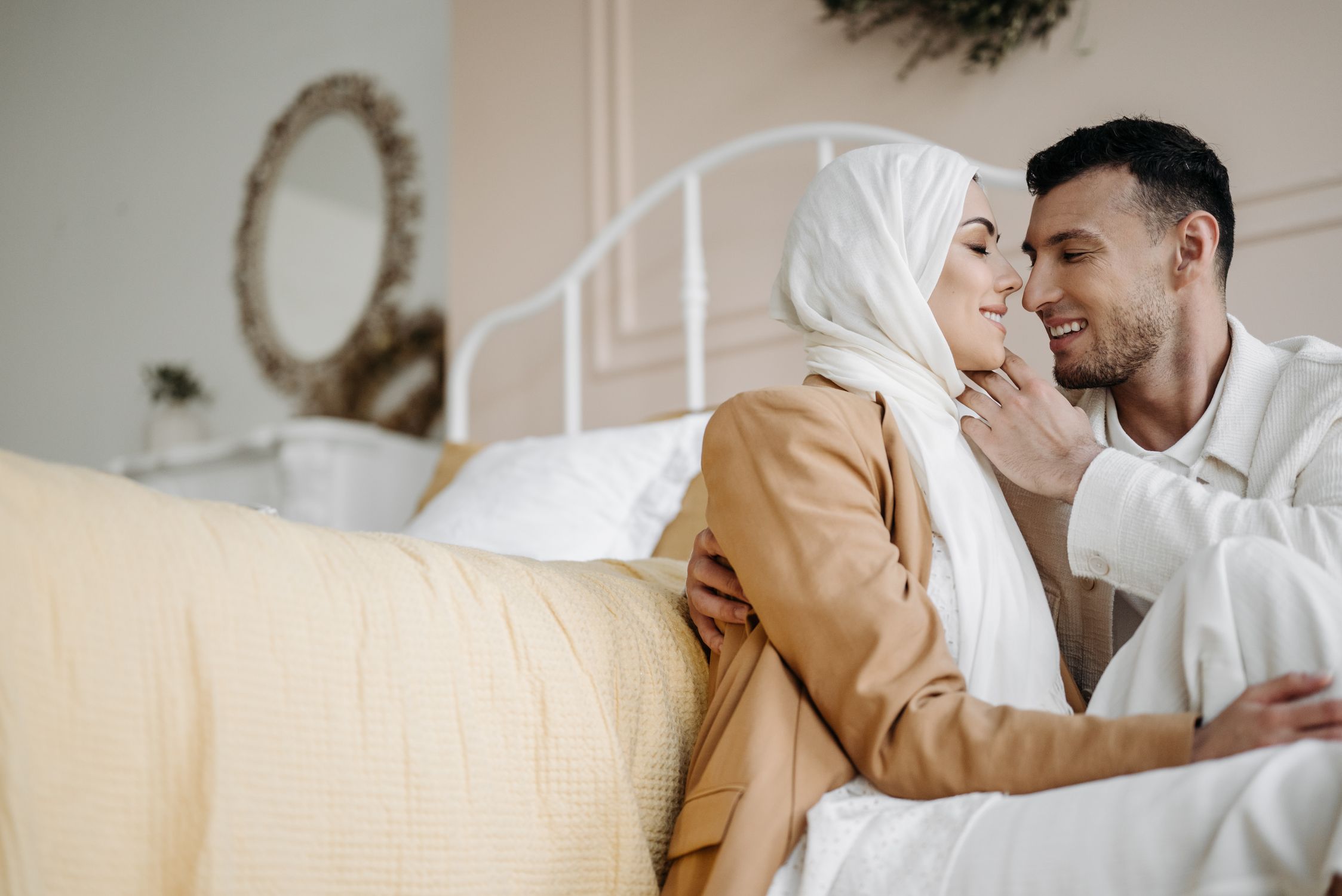 Close Up Photo of Man and Woman Sitting on the Floor Beside Bed · Free ...