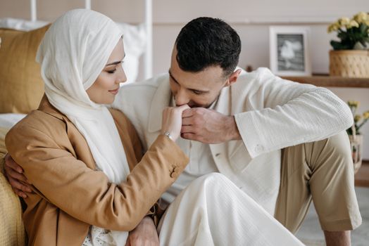 A loving couple sharing an affectionate moment, highlighting their connection and cultural attire.